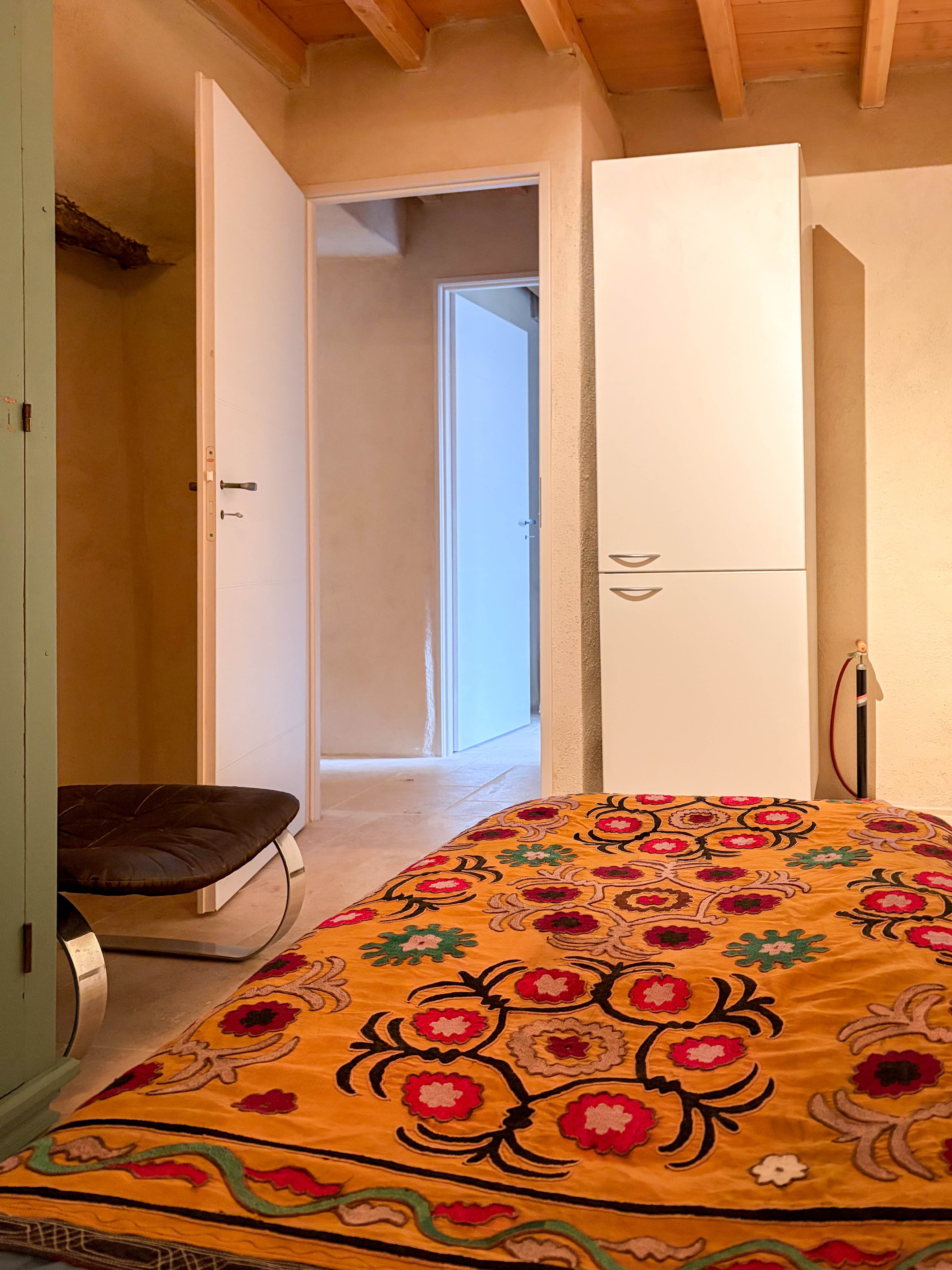 Second bedroom with colorful Suzani bedding and mint wardrobe