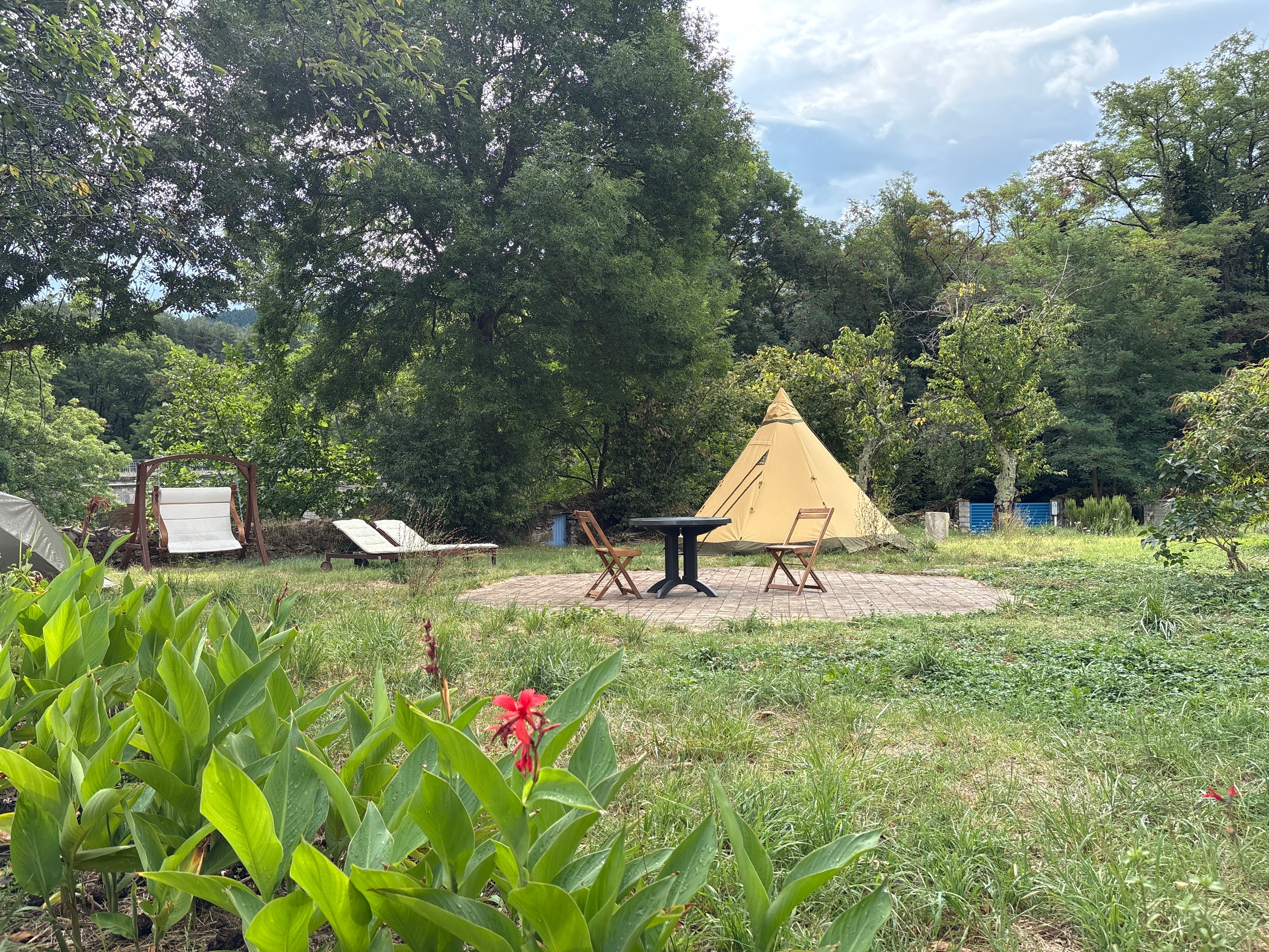 Wild riverside garden with tipi